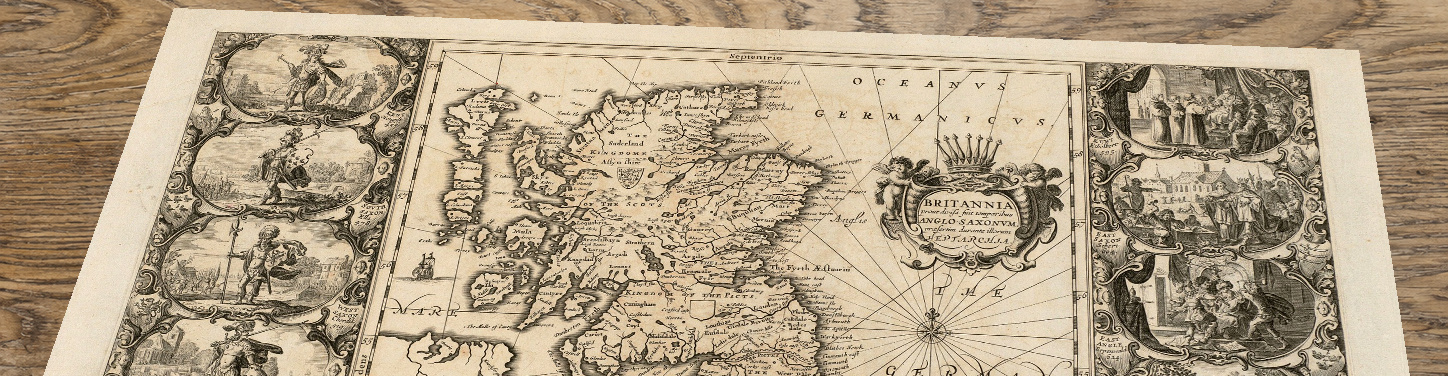 Upper section of the britannia map lying at an angle on an antique ash table