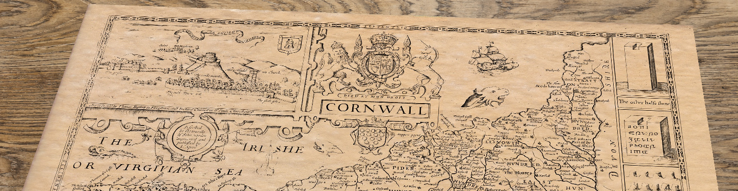 Upper section of John Speed’s Cornwall map lying at an angle on an antique ash table