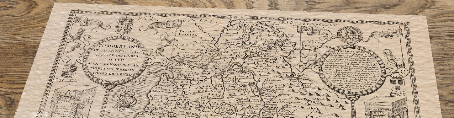 Upper section of Old Map of Cumberland, lying at an angle on an antique ash table