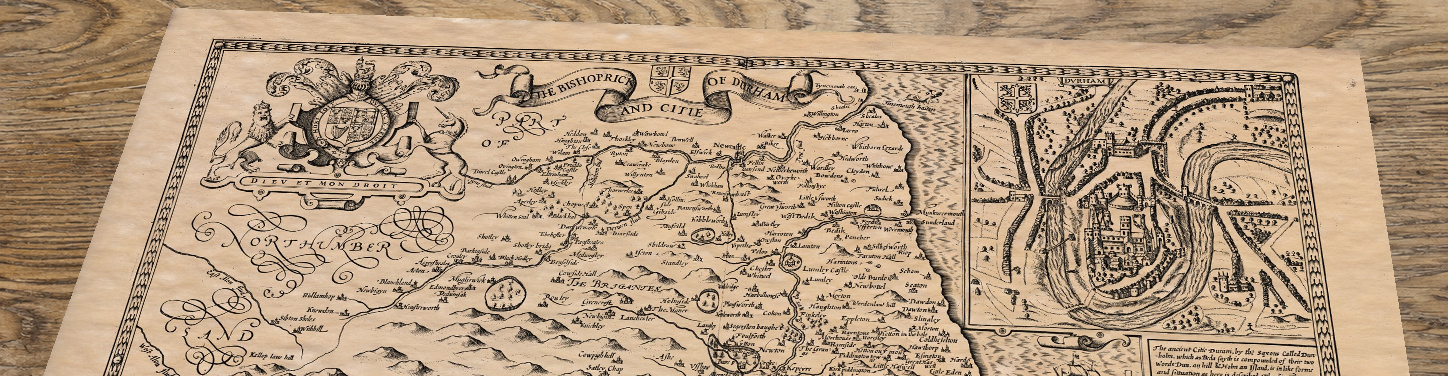Upper section of Old Map of Durham, lying at an angle on an antique ash table