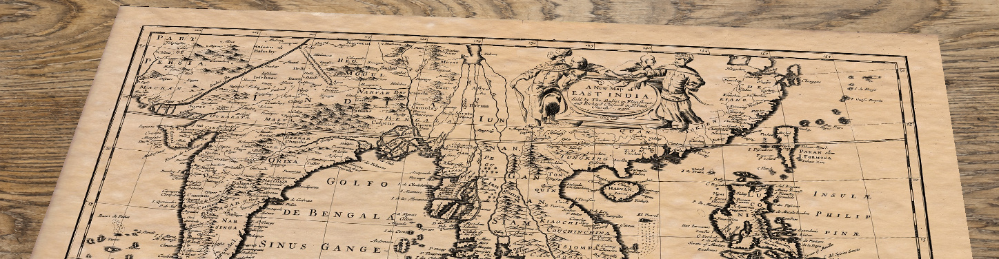 Upper section of East India - an old map by John Speed, lying at an angle on an antique ash table