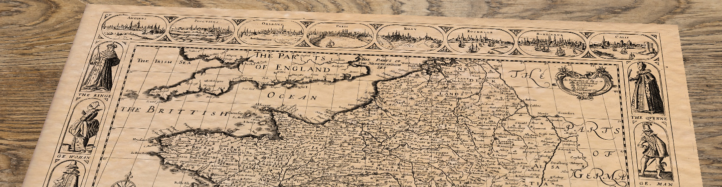 Upper section of France - an old map by John Speed, lying at an angle on an antique ash table