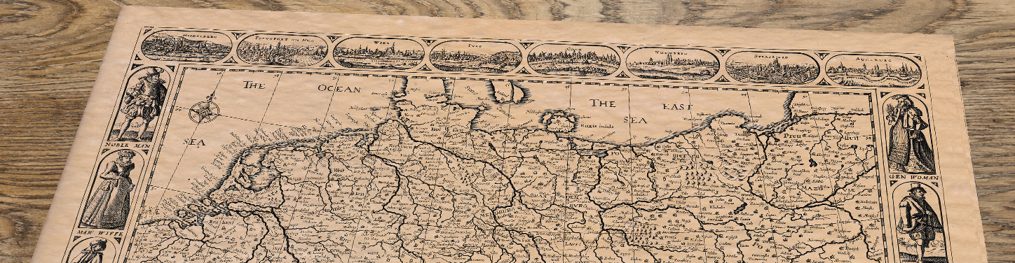 Upper section of Old Map of Germany by John Speed, 1626, lying at an angle on an antique ash table