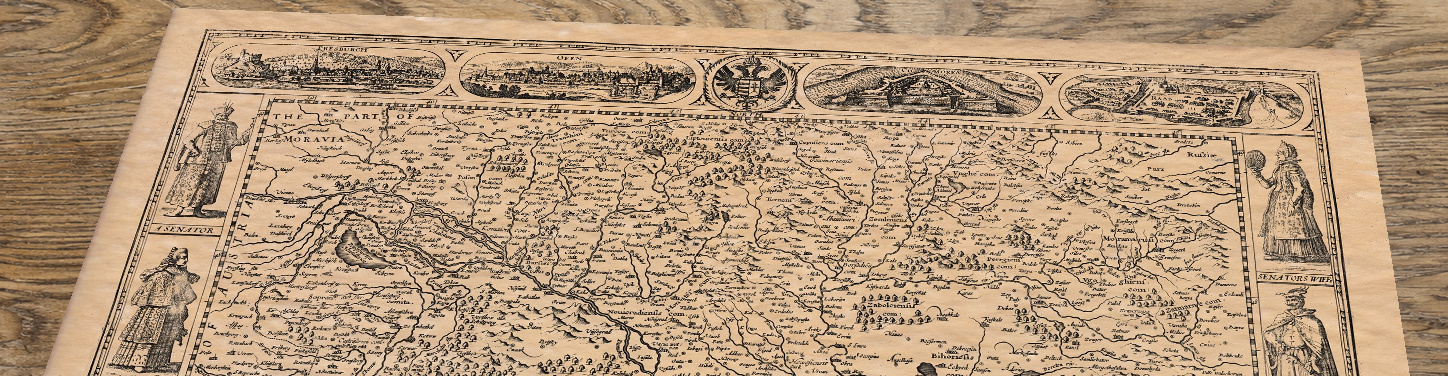Upper section of Old Map of Hungary by John Speed, 1626, lying at an angle on an antique ash table