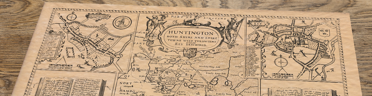 Upper section of Old Map of Huntingdonshire, lying at an angle on an antique ash table