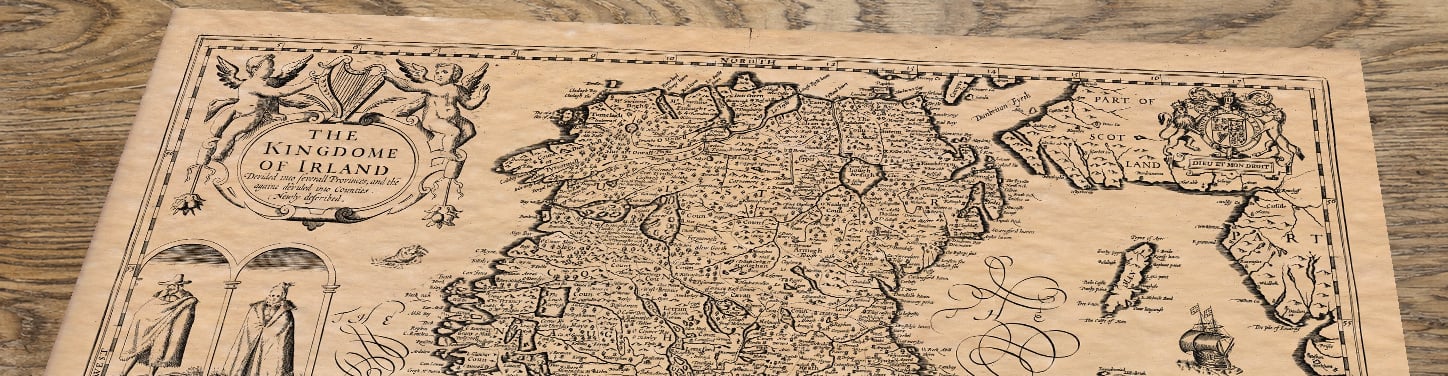 Upper section of Ireland - an old map by John Speed, lying at an angle on an antique ash table