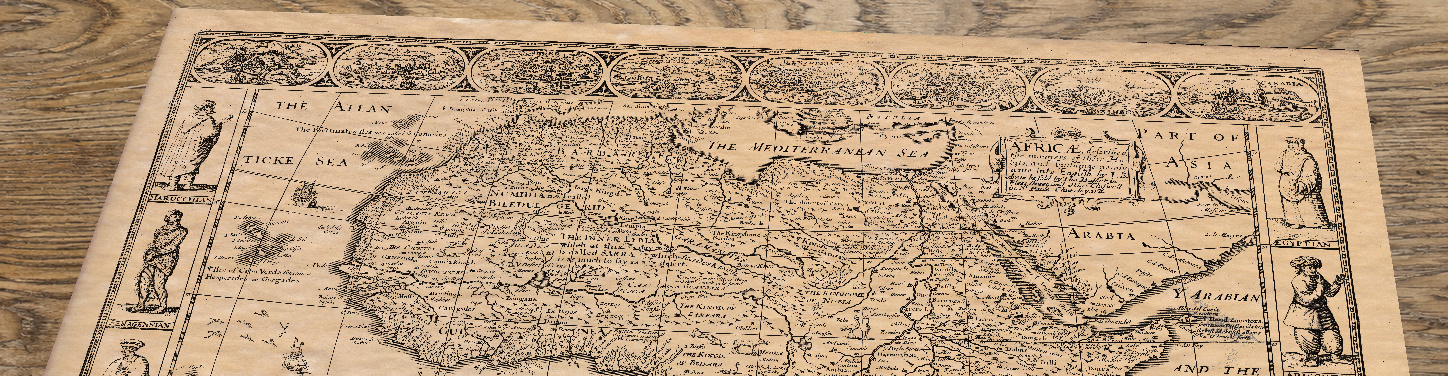 Upper section of Africa: An Old Map by John Speed, lying at an angle on an antique ash table