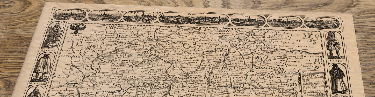 Upper section of Bohemia - an old map by John Speed, lying at an angle on an antique ash table