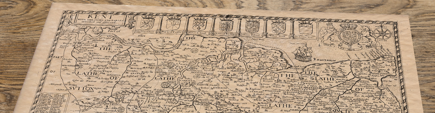 Upper section of Old Map of Kent, lying at an angle on an antique ash table