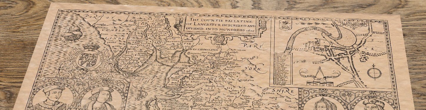 Upper section of Old Map of Lancashire by John Speed, 1610, lying at an angle on an antique ash table