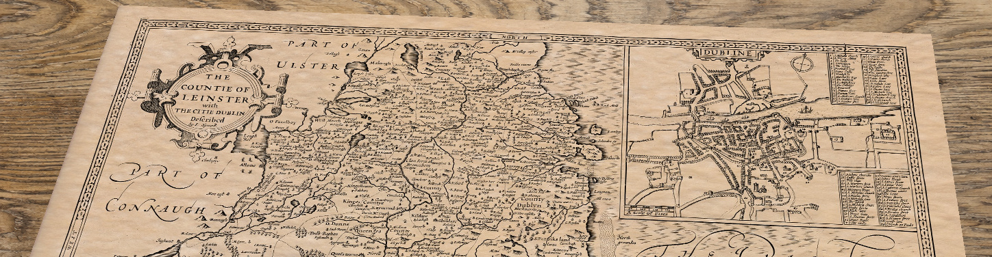 Upper section of Old Map of Leinster, lying at an angle on an antique ash table