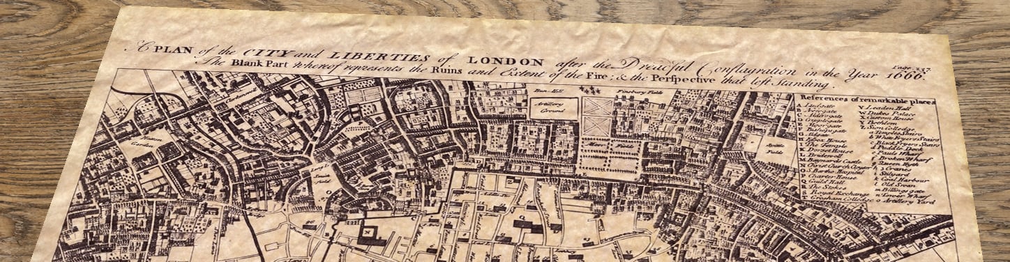 Upper section of Great Fire of London Map – The City after 1666, lying at an angle on an antique ash table