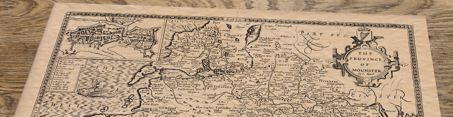 Upper section of Munster Ireland - an old map by John Speed, lying at an angle on an antique ash table