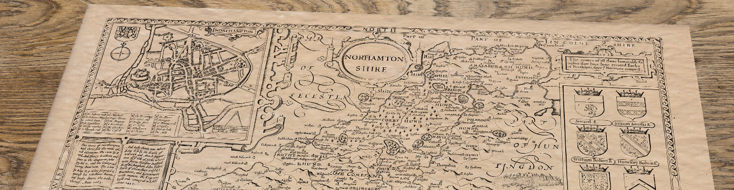 Upper section of Old Map of Northamptonshire, lying at an angle on an antique ash table