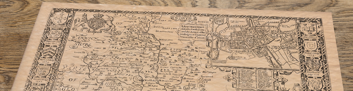 Upper section of Old Map of Oxfordshire, lying at an angle on an antique ash table