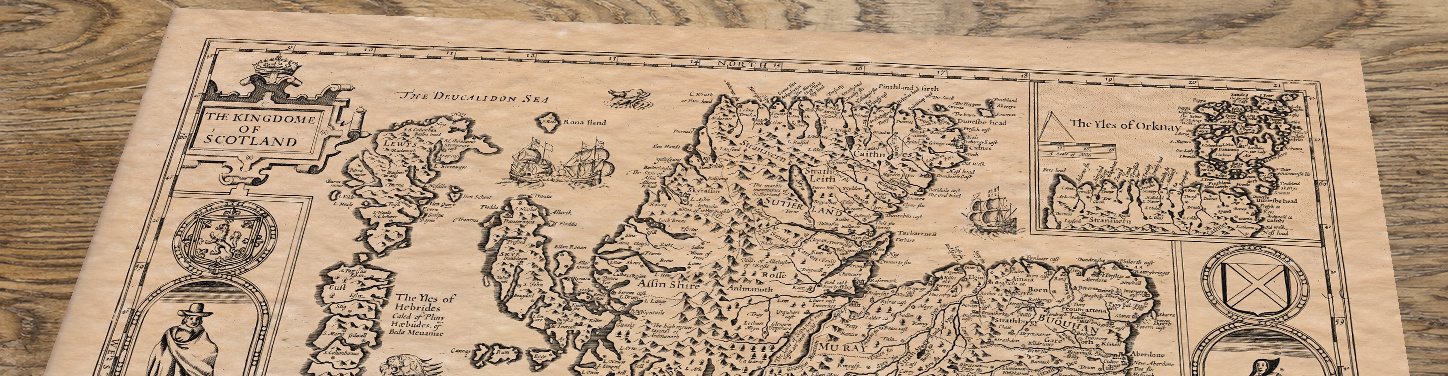 Upper section of Old Map of Scotland by John Speed, lying at an angle on an antique ash table